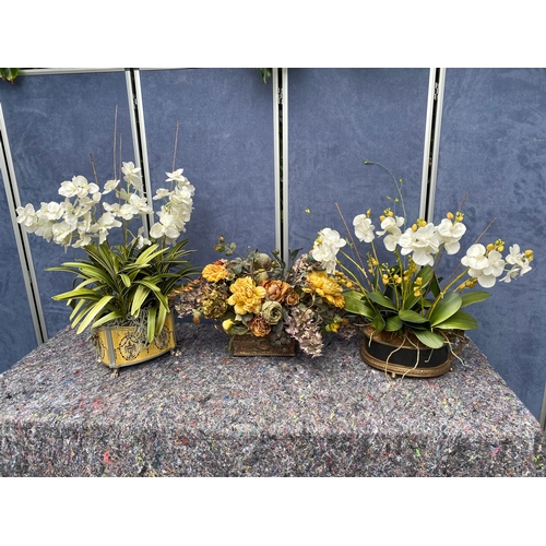 85 - A trio of artificial flower display pieces.