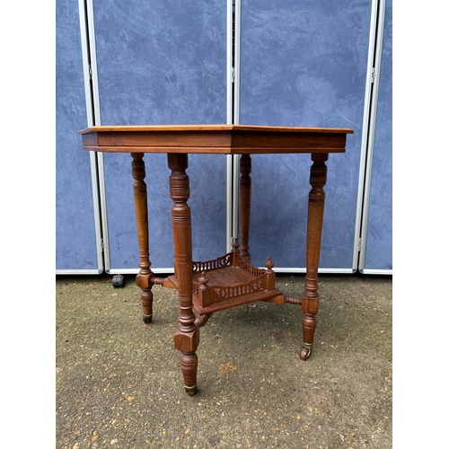 233 - Antique two tier Octagonal table on wheels. 

Dimensions - 28.5