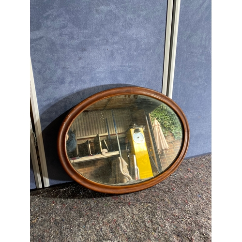 351 - A wooden framed oval mirror.