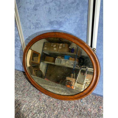 351 - A wooden framed oval mirror.