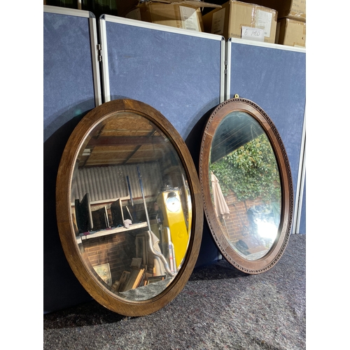 353 - Two vintage oval mirrors.