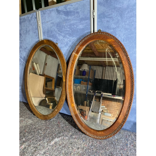 353 - Two vintage oval mirrors.