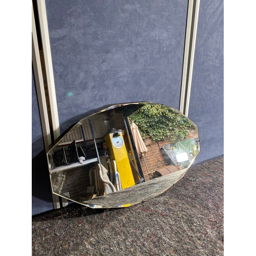 393 - Oval shaped bevelled edge mirror.