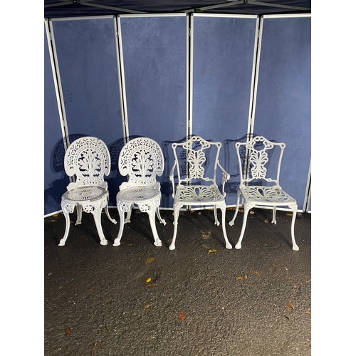 508 - Vintage White painted cast garden table and four chairs.