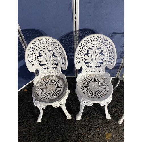 508 - Vintage White painted cast garden table and four chairs.