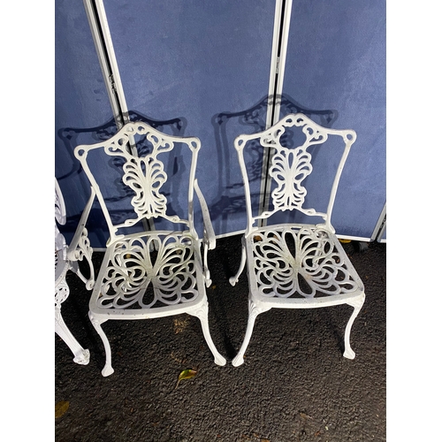 508 - Vintage White painted cast garden table and four chairs.