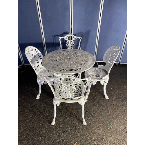 508 - Vintage White painted cast garden table and four chairs.