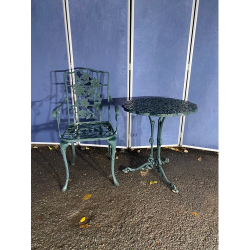 510 - Vintage cast garden side table and chair in green.