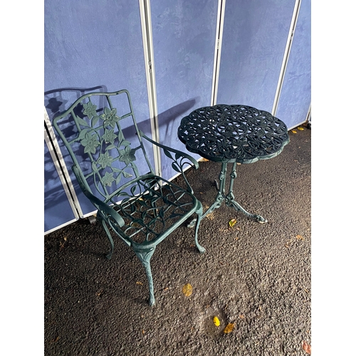 510 - Vintage cast garden side table and chair in green.