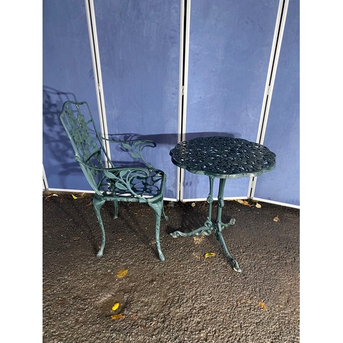 510 - Vintage cast garden side table and chair in green.