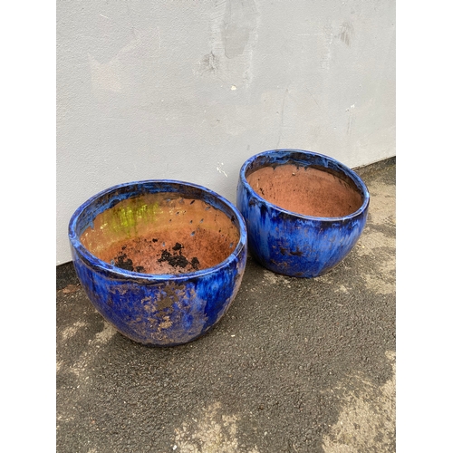 516 - A pair of large blue glazed plant pot.