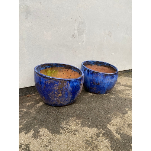 516 - A pair of large blue glazed plant pot.