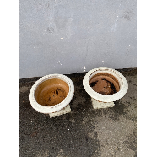 518 - A pair of terracotta urn style plant pots.