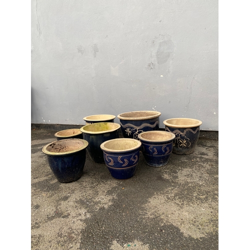 521 - A lot of decorative dark blue glazed garden pots.