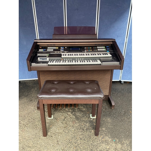 540 - Electric technics organ with stool and contents.