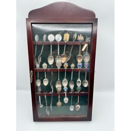 165 - Collection of collectable tea spoons in display case