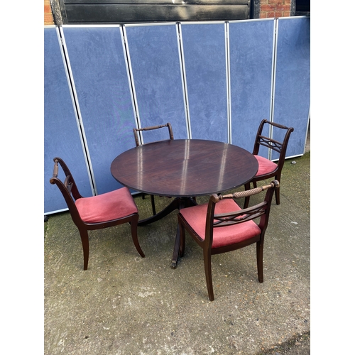 200 - Mahogany extendable dining table and four chairs.