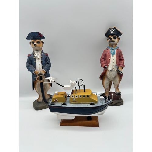 83 - Two meerkat models + model boat