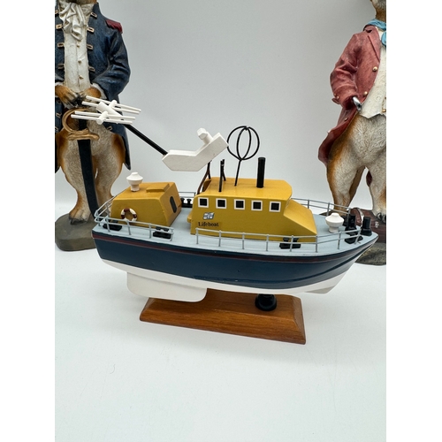 83 - Two meerkat models + model boat