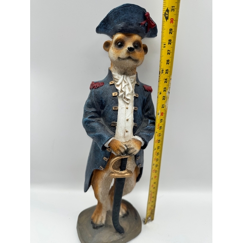 83 - Two meerkat models + model boat