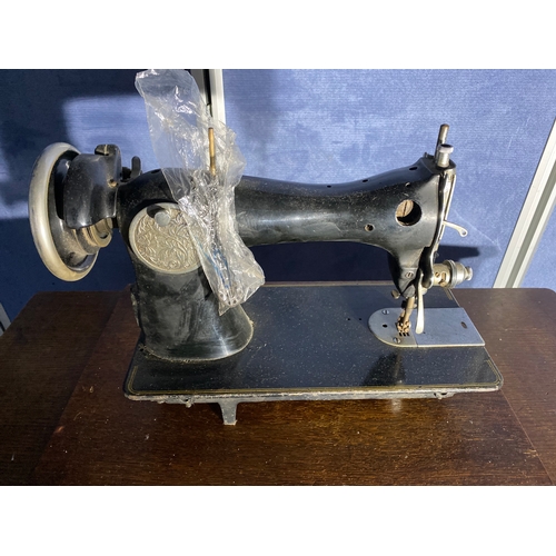 331 - Antique Singer sewing machine and table.