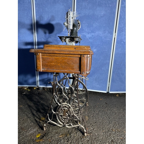 331 - Antique Singer sewing machine and table.