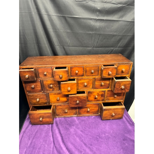 156 - Vintage Solid Teak Apothecary Cabinet of 22 drawers of graduating size 90.5cm x 25cm x 57cm