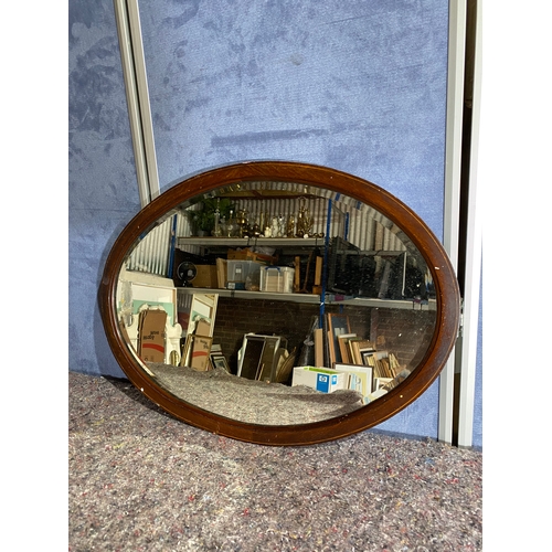 570 - Oval Wooden framed bevelled edge mirror. 

Dimensions - 28