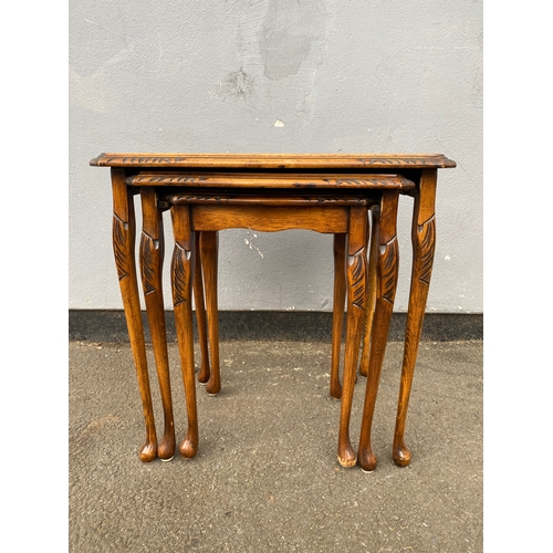 604 - Antique serpentine nest of three tables with inlaid green leather and glass protective tops. 

Dimen... 