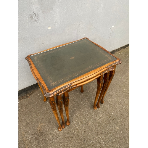 604 - Antique serpentine nest of three tables with inlaid green leather and glass protective tops. 

Dimen... 