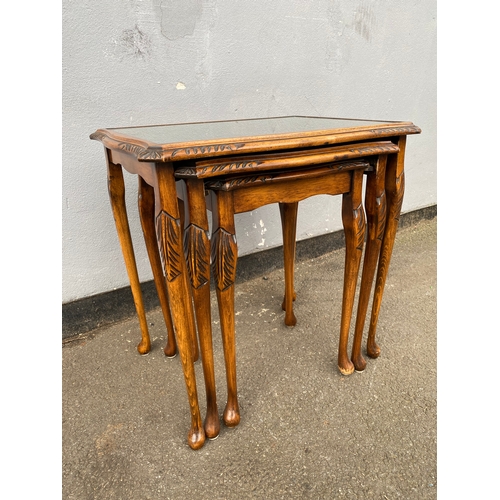 604 - Antique serpentine nest of three tables with inlaid green leather and glass protective tops. 

Dimen... 