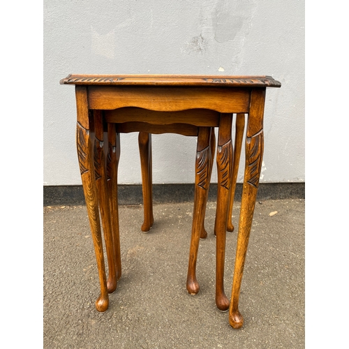 604 - Antique serpentine nest of three tables with inlaid green leather and glass protective tops. 

Dimen... 