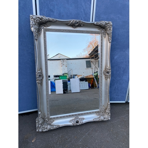 620 - Ornate rectangular silver framed bevelled edge mirror. 

Dimensions - 35