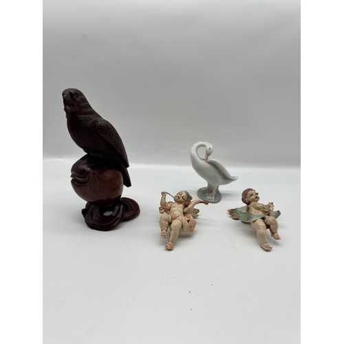 284 - Carved wooden bird, two cherubs, Lladro duck