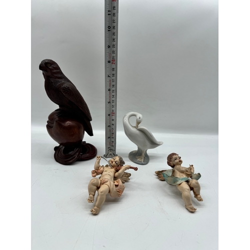 284 - Carved wooden bird, two cherubs, Lladro duck