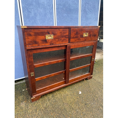 306 - Campaign style bookcase with two drawers. 

Dimensions - 47.5