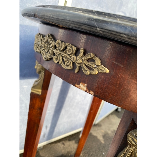 339 - A pair of French Empire Style hardwood and ormolu mounted circular tables, the black moulded marble ... 