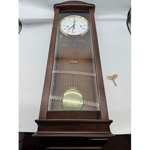 59 - Fine Kieninger Pendulum wall Clock with white enamel face in mahogany and glazed cased - second repe... 