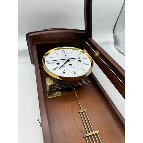 59 - Fine Kieninger Pendulum wall Clock with white enamel face in mahogany and glazed cased - second repe... 