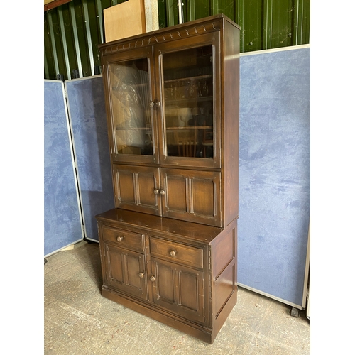 458 - Dark Ercol Blue label glazed cabinet over cupboard

Please see images for all dimensions.