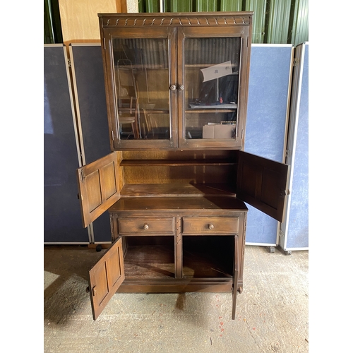 458 - Dark Ercol Blue label glazed cabinet over cupboard

Please see images for all dimensions.