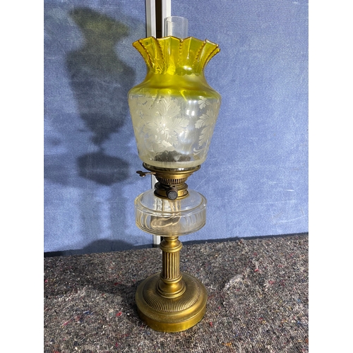 565 - A pair of brass and coloured glass etched shades paraffin lamps. One has been converted