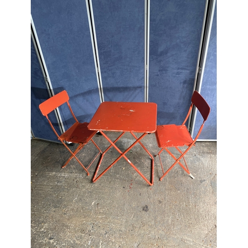 582 - Vintage Orange foldable garden / bistro table and two chairs.