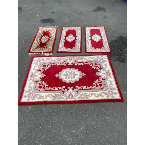 591 - A lot of four Indian Aubusson style Red rugs / carpets