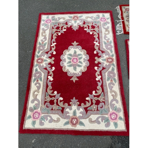 591 - A lot of four Indian Aubusson style Red rugs / carpets