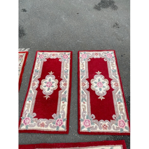 591 - A lot of four Indian Aubusson style Red rugs / carpets