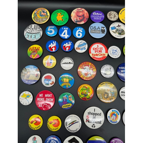 43 - Large collection of 1980's Tin Badges including Ghostbusters / TMNT, E.T + other British brands