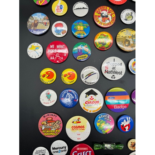 43 - Large collection of 1980's Tin Badges including Ghostbusters / TMNT, E.T + other British brands