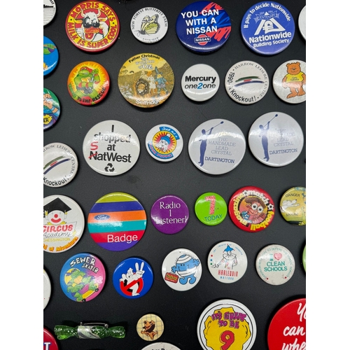 43 - Large collection of 1980's Tin Badges including Ghostbusters / TMNT, E.T + other British brands