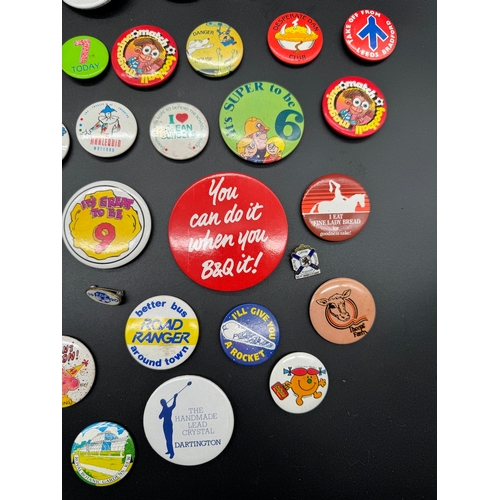 43 - Large collection of 1980's Tin Badges including Ghostbusters / TMNT, E.T + other British brands